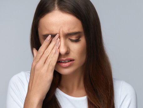 woman scratching her eye
